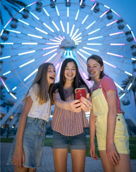 Teens taking selfies at The Wharf in Orange Beach, AL