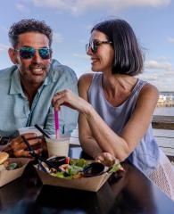 Couple dining at Avenue Pub waterfront restaurant in Orange Beach