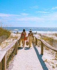 Family walking along path to the beach in Gulf Shores