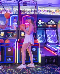 A couple playing game at The Track arcade.
