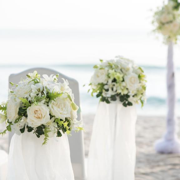 wedding chairs set up on the beach