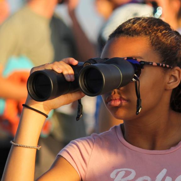 girl with binoculars at foley sport event