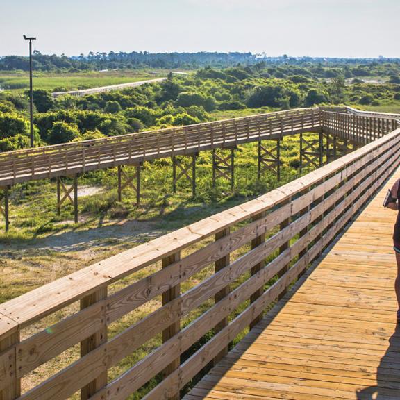 Woman Running on Boardwalk in Gulf Shores