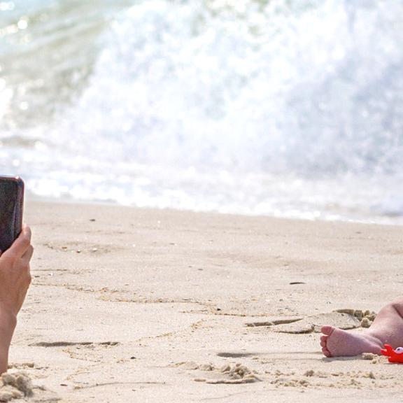 Mom taking pictures of son on Alabama's Beaches