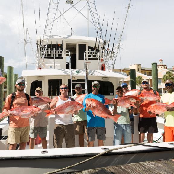 group shot of men on fishing boat with their catch Orange Beach