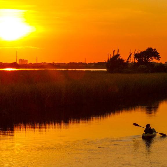 Kayakers watch Sunset in Orange Beach