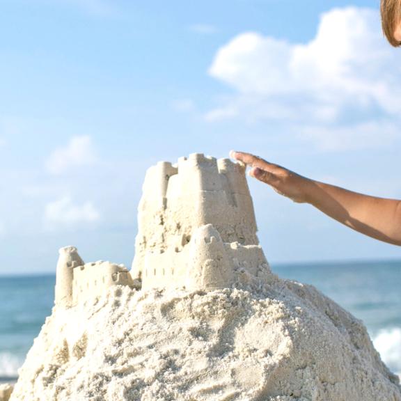Boy building sand castle on Alabama's Beaches