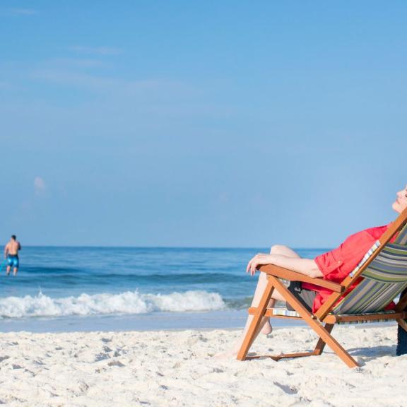 Woman lounging on the beach in Orange Beach, AL