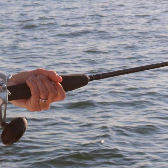 Woman deep sea fishing in Orange Beach, AL