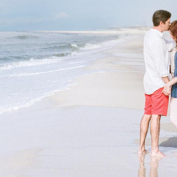 Couple holding hands on Alabama's Beaches