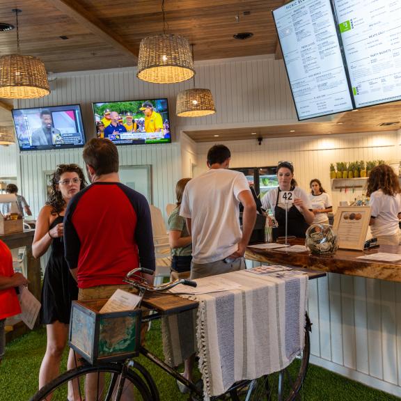 people getting food to go at a restaurant