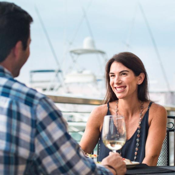 couple drink wine at The Wharf Orange Beach AL