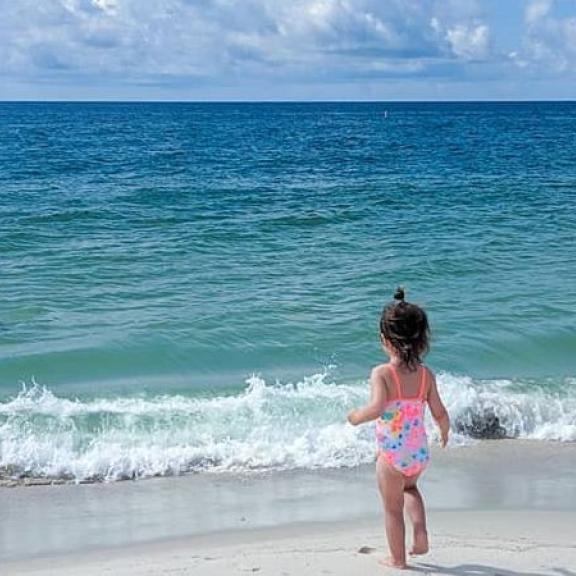 Young girl playing on the beach in Orange Beach, AL