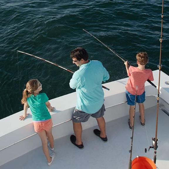Dad and kids fishing in Orange Beach, AL