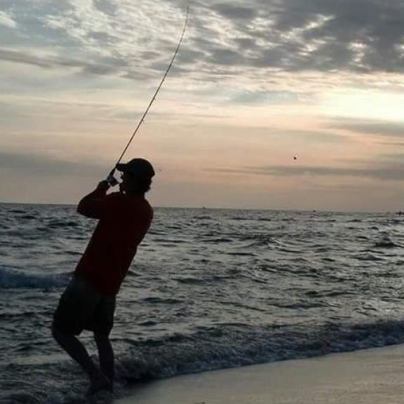 Man shore fishing in Gulf Shores, AL