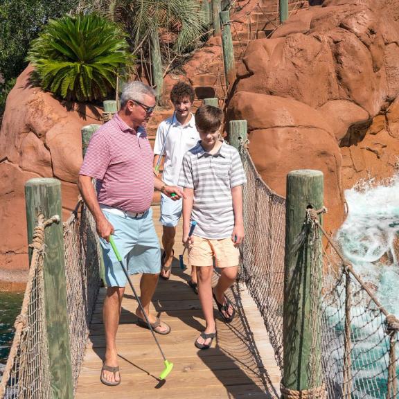 Family playing mini golf at Adventure Island in Orange Beach, AL
