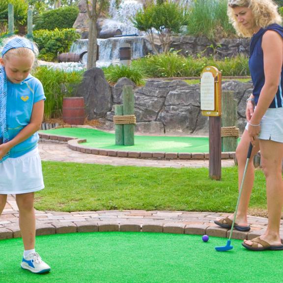 Family playing mini golf