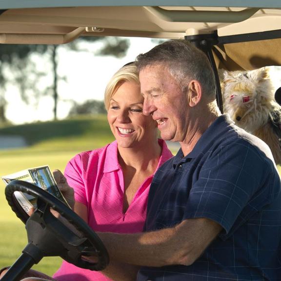 Couple golfing on Alabama Gulf Coast