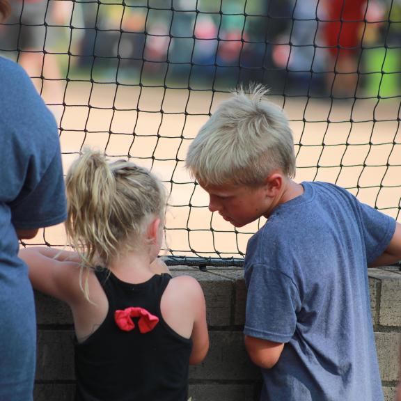 Kids watching a baseball game in Gulf Shores