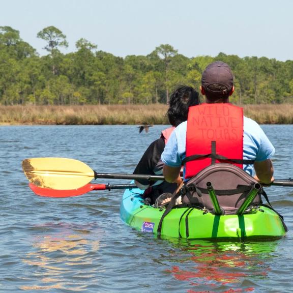 Couple on a dolphin kayak tour with Wild Native Tours