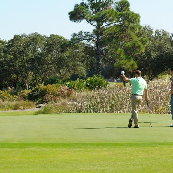 Group of friends playing golf at Kiva Dunes Golf Course in Fort Morgan