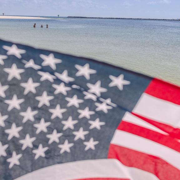 American flag waving in front of the Gulf at Perdido Pass Beach I=