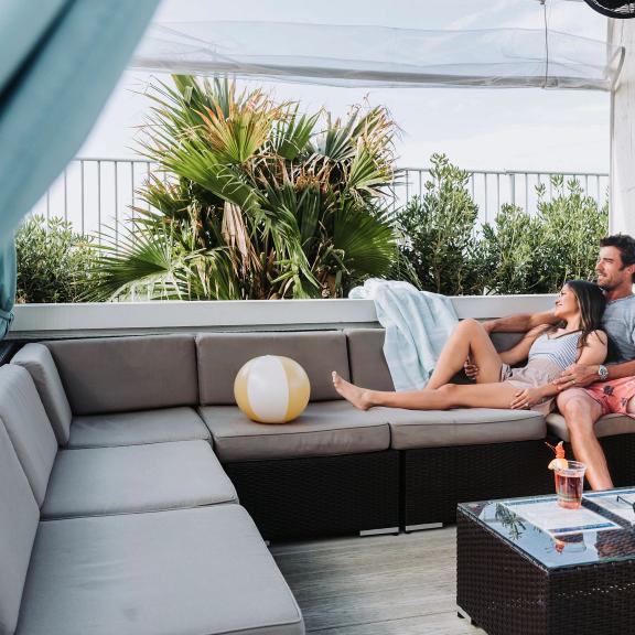 couple relaxing in a private cabana at the lazy river at the caribe