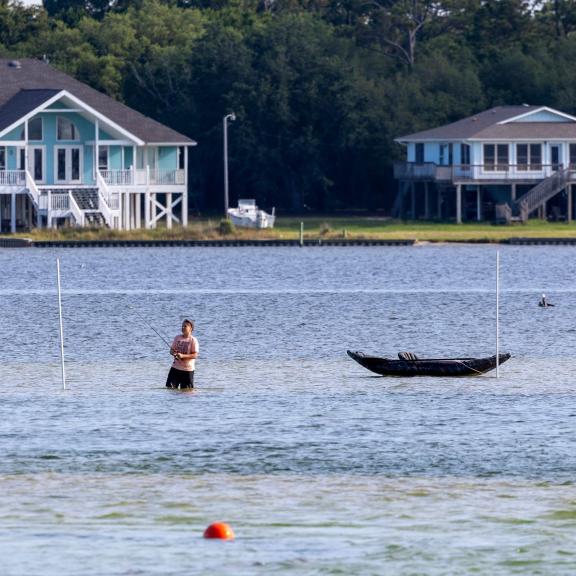 Angler wade fishing in Little Lagoon in Gulf Shores