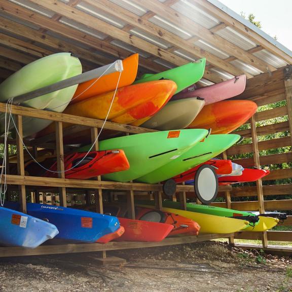 stack of colorful kayaks at the Wind & Water Learning Center in Orange Beach