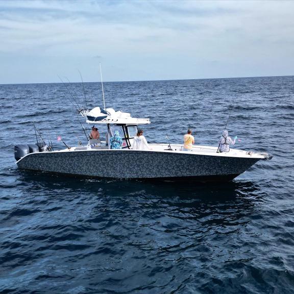 Aerial of charter boat filled with anglers offshore fishing in Orange Beach