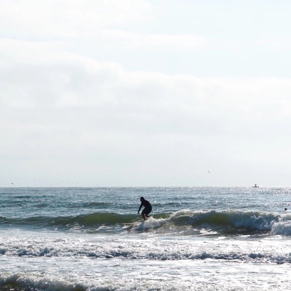 Man surfing in the Gulf at Cotton Bayou in Orange Beach