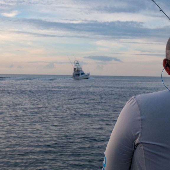 Angler looking out in the Gulf on an offshore charter boat in Orange Beach