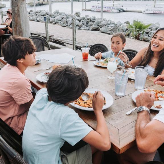 Family dining at Cobalt waterfront seafood restaurant in Orange Beach