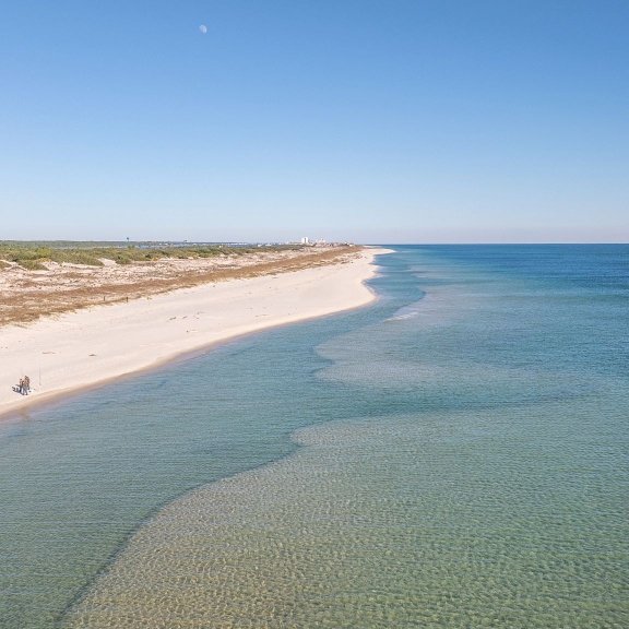 aerial view of white sand beaches and turquoise waters in Fort Morgan