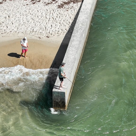 Anglers shore fishing at Little Lagoon Pass Park in Gulf Shores