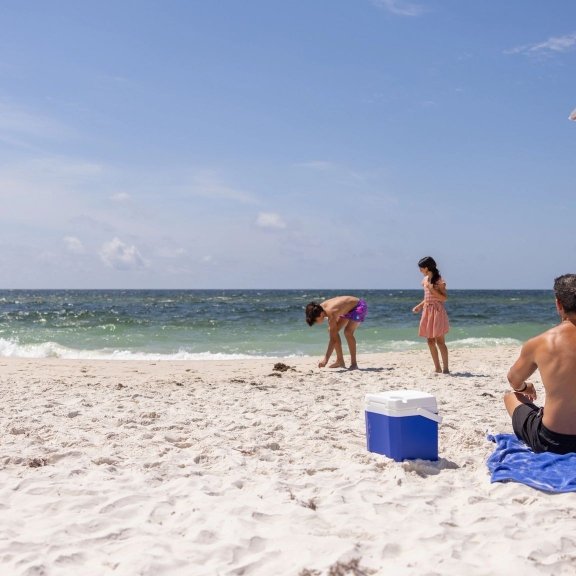 Dad and kids on the beach in Gulf Shores
