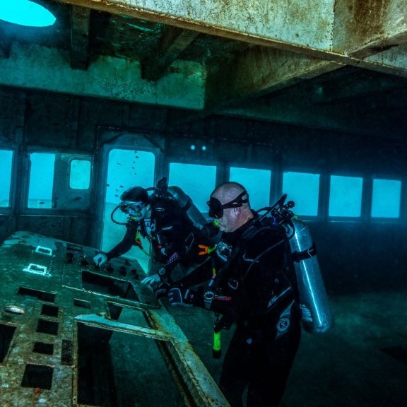cuba divers exploring the bridge and control console of the Fairfield New Venture shipwreck off the Alabama Coast.