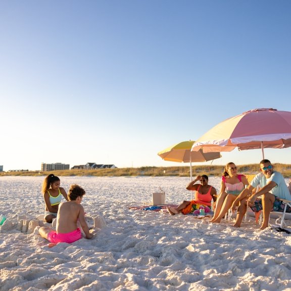 Family relaxing on the beach in Gulf Shores