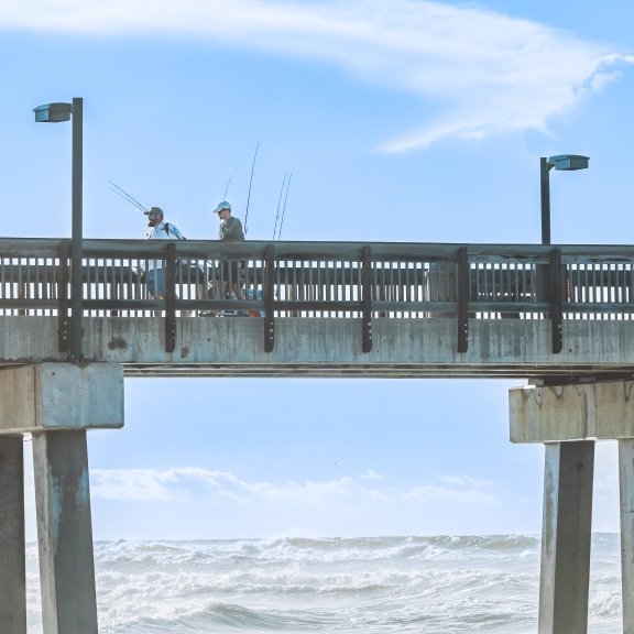 People walking along the Gulf State Park Fishing Pier in Gulf Shores