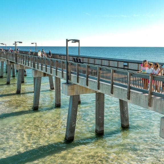 Drone view of family walking along the Gulf State Park Pier in Gulf Shores