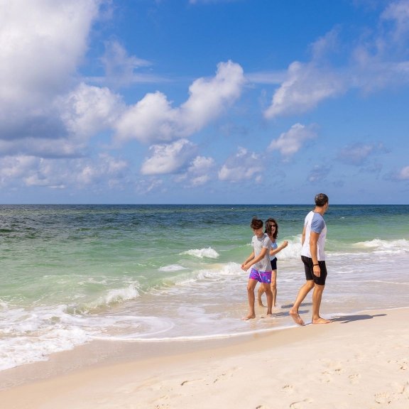 Family playing in the surf on the beach in Gulf Shores