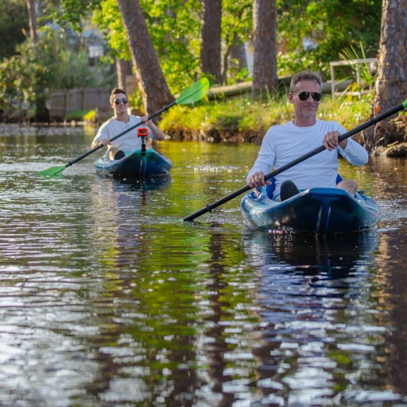 Men kayaking in the calm backbars of Orange Beach