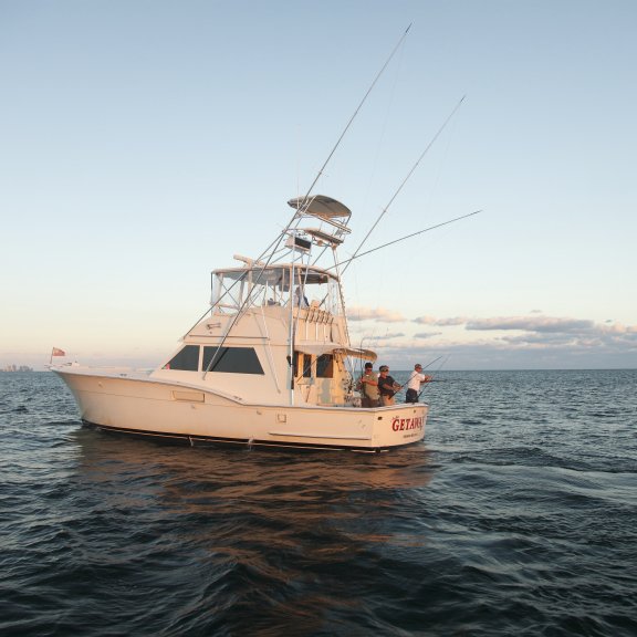 Orange Beach Charter Boat sailing into the Gulf at sunrise