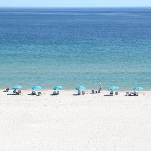 Aerial view of the white sand and turquoise waters of the beach in Gulf Shores