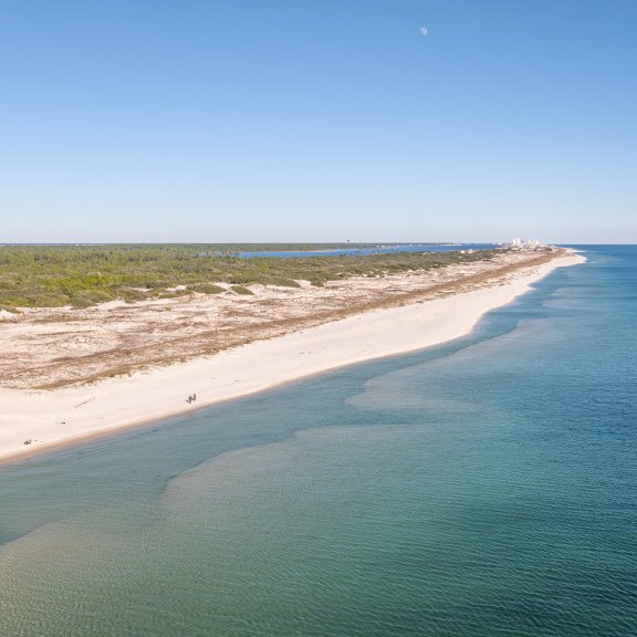 Scenic, aerial view of turquoise waters and white sand beaches of Fort Morgan