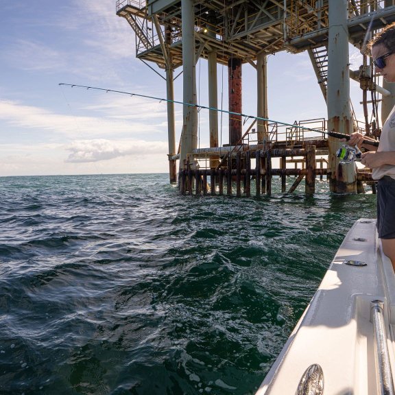 Angler rig fishing on an offshore fishing charter in Gulf Shores