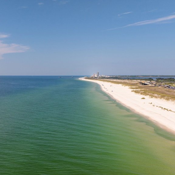 Drone view of shoreline and water in Gulf Shores