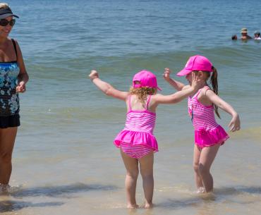 little girls playing on the beach