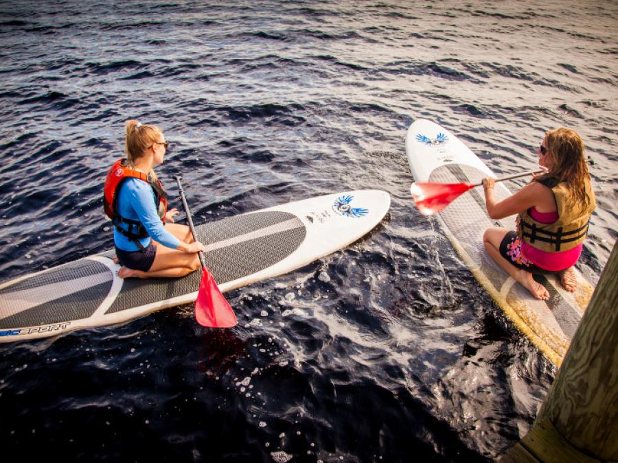 Girls paddleboarding Orange Beach