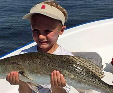 Little boy with a big trout in Gulf Shores, AL